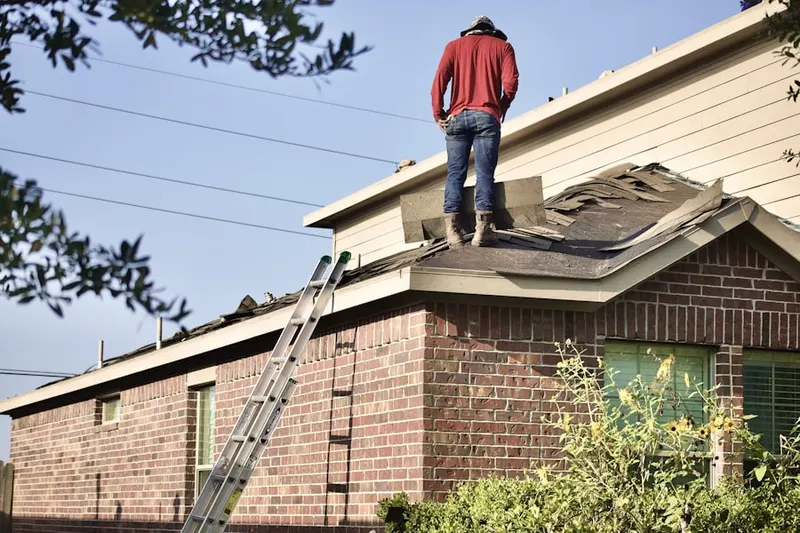 Professional roofer working on a residential roof in Masonicus